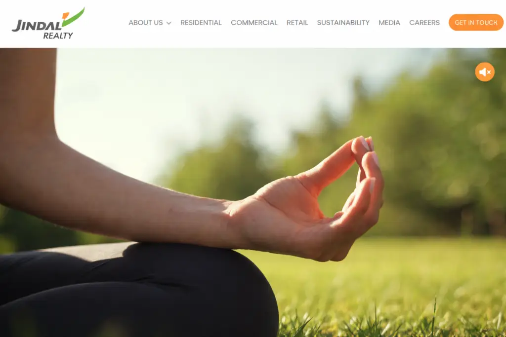 Jindal Realty website hero section design with meditation hand gesture and modern real estate website header layout
